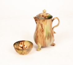 An English creamware Whieldon type jug and cover and a tea bowl, decorated in running brown,