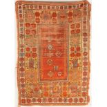 A Melas rug, West Anatolia, circa 1870, the plain madder field with scattered stellar motifs,