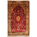 A Turkish prayer rug, the strawberry red field of birds and animals centred by a peach medallion,