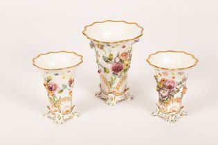 A garniture of three Spode vases, of flared form, encrusted with flowers, on four feet, shape 4649,