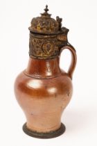 A Rhineland brown salt glazed stoneware jug with gilt metal mounts,