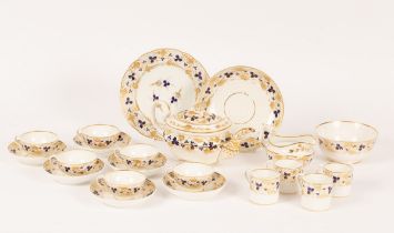 A Derby porcelain tea service, circa 1810, painted in blue and gilt with a band of fruiting vines,