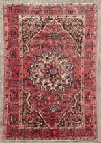 A Bakthiar carpet, West Persia, mid 20th Century, the madder field centred by an ivory medallion,