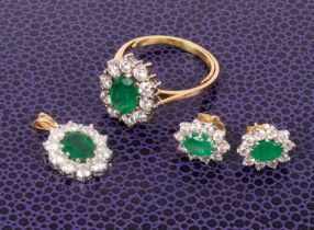 An 18ct yellow gold emerald and diamond oval cluster ring