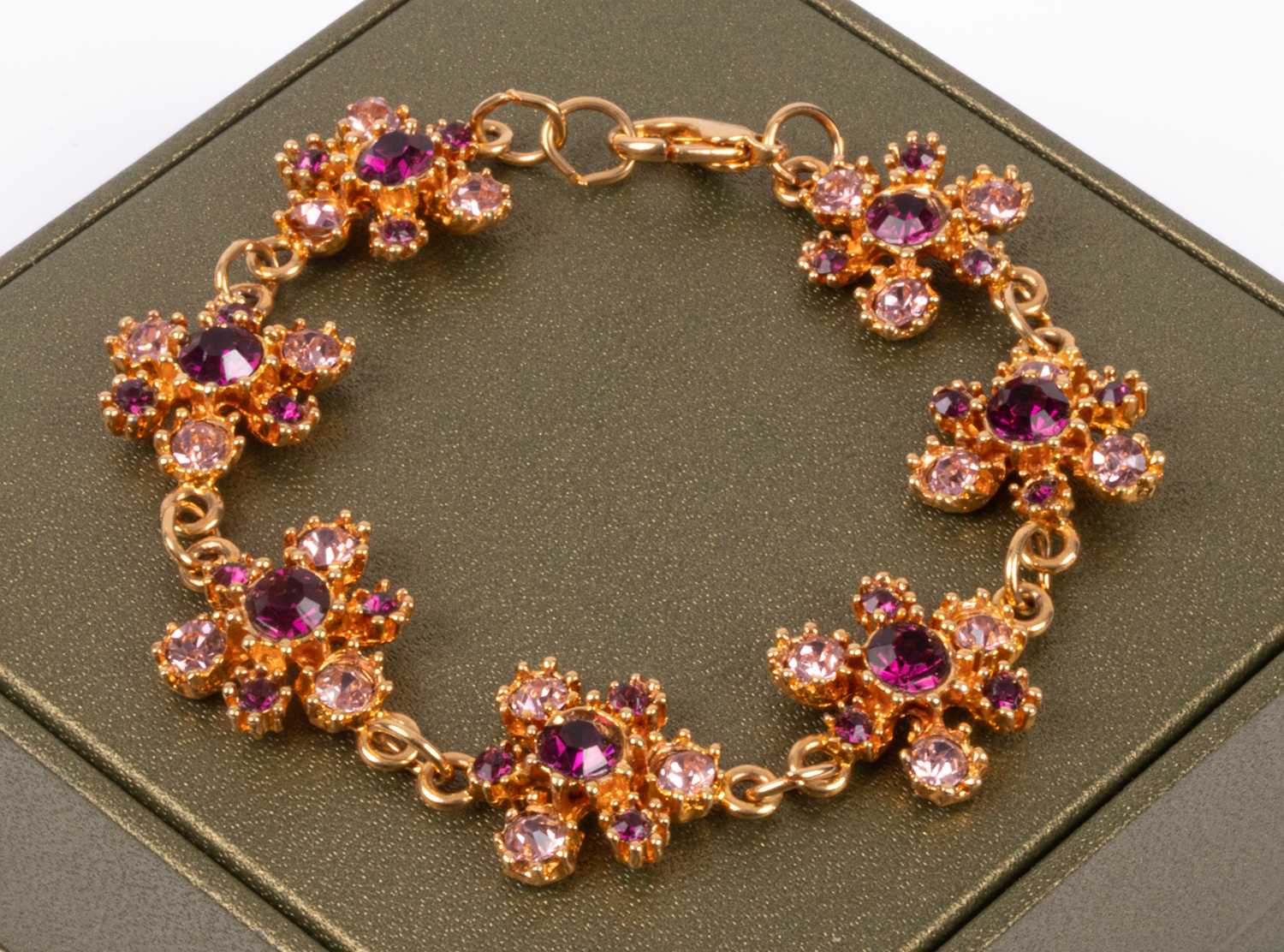 A costume jewellery yellow metal and amethyst coloured stone mounted bracelet