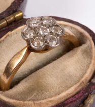An Edwardian 18ct gold and diamond flower head ring