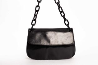 A Prada black patent handbag