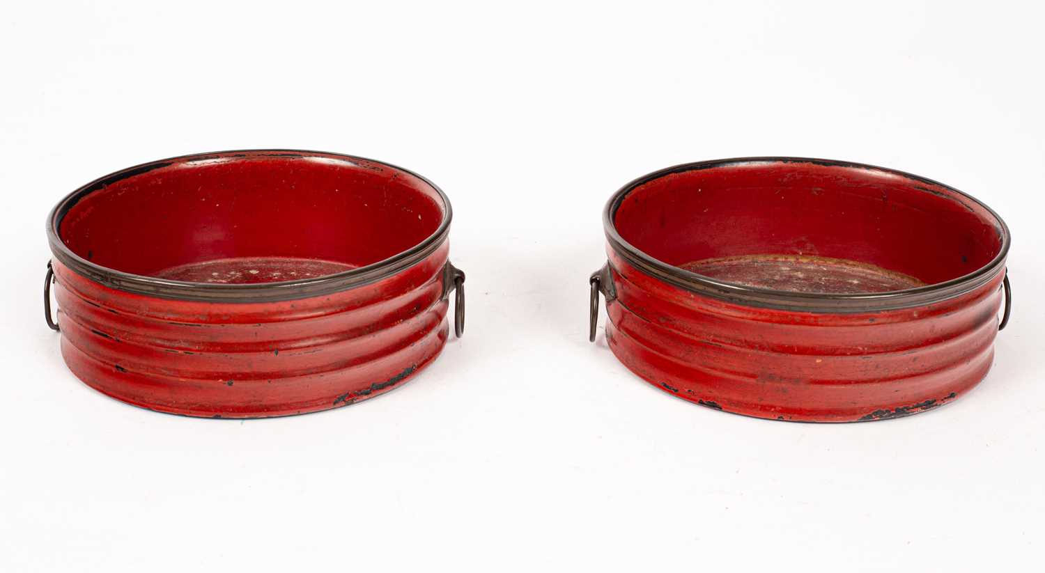 A pair of Regency red lacquer wine coasters,