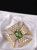 An 18ct gold diamond and peridot cross brooch