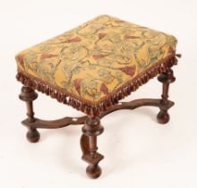 A William & Mary stool with upholstered top, on turned umbrella-type legs and flat stretcher,