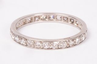 A diamond eternity ring, set in white precious metal, size N approximately 2.