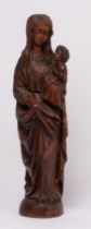 A carved wooden figure of a mother and child,