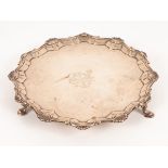 A George III silver salver, EC, London 1763, with shaped scalloped edge and central armorial,