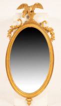A Regency giltwood mirror, the eagle crest holding a chair with two balls,
