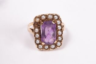 An amethyst and seed pearl ring, the central amethyst approximately 10mm x 7mm,