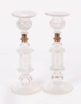 A pair of 19th Century heavy cut glass candlesticks, octagonal step-cut stems and petal feet,