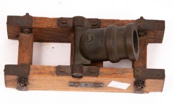 A small squat cannon on a metal mounted oak base, 18.