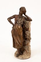 A bronzed metal figure of a maiden, her left arm resting on a pillar and supporting her head,