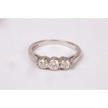 A diamond three-stone ring, claw set to an 18ct white gold band, size J/K,