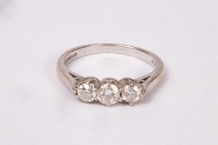 A diamond three-stone ring, claw set to an 18ct white gold band, size J/K,