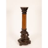 An Edwardian torchère with ebonised circular top on a hexagonal walnut and marquetry column the