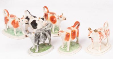 A collection of six Staffordshire cow creamers,