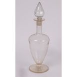 A pharmacists glass carboy with pointed stopper on a circular star-cut base, 54cm high,