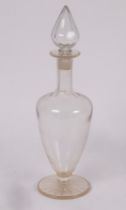 A pharmacists glass carboy with pointed stopper on a circular star-cut base, 54cm high,