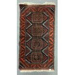 A Bokhara rug, Afghanistan, the maroon field with four octagonal Turkmen type medallions,