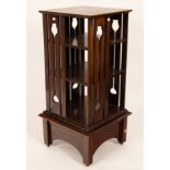 An oak revolving bookcase, early 20th Century, with tulip decoration, 44.