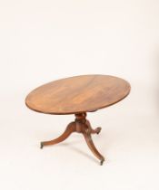 A mahogany oval breakfast table of Regency design,