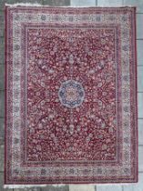 A large machine made carpet of Tabriz design,