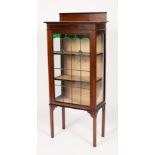 An Edwardian mahogany display cabinet, with leaded glass door enclosing three shelves,