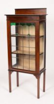 An Edwardian mahogany display cabinet, with leaded glass door enclosing three shelves,