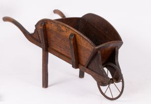 A Victorian oak wheelbarrow with metal front wheel,