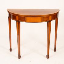 A mahogany half-round hall table, banded in satinwood and fitted a drawer to the frieze,