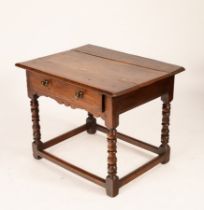 An oak side table, late 17th Century, single drawer on turned supports united by square stretchers,
