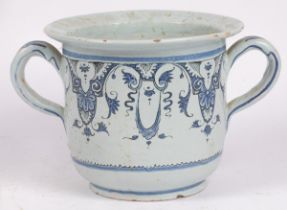 A Faience two-handled pot, painted with scrolling foliage,