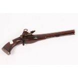A flintlock pistol with embossed floral barrel top and acorn finial to the trigger, with ramrod,