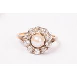 A pearl and diamond cluster ring, the central pearl to a halo of ten diamonds,