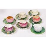 A set of five Minton rose-form cups and saucers, a Minton water lily form cup and saucer,