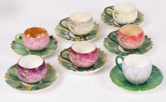 A set of five Minton rose-form cups and saucers, a Minton water lily form cup and saucer,