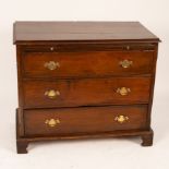 An oak chest of three long drawers, 19th Century, with brush slide,
