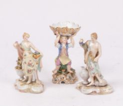 A pair of Dresden figures, male and female figures holding flowers and grapes,