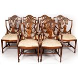 Ten mahogany shield back dining chairs with loose trap seats on square chamfered legs with spade