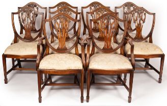 Ten mahogany shield back dining chairs with loose trap seats on square chamfered legs with spade