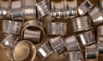 A set of six silver napkin rings, Walker & Hall, Birmingham 1930-33, initialled and nineteen others,