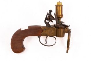 A flintlock taper lighter with engraved plates and candle to the side,