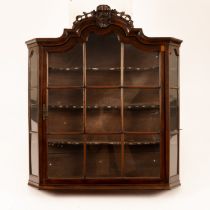 An 18th Century and later Dutch walnut glazed hanging cabinet with pierced and carved surmount,