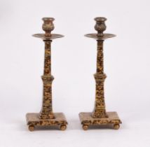 A pair of faux tortoiseshell candlesticks, with silver plated mounts,